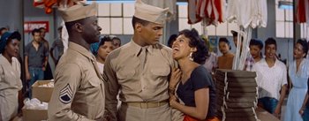 Movie still from “Carmen Jones” (1954), directed by Otto Preminger – A man and a woman in a military uniform; Medium shot, Over the shoulder angle