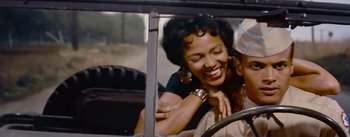 Movie still from “Carmen Jones” (1954), directed by Otto Preminger – A woman is hugging another woman in a car; Close Up shot, Over the shoulder angle