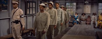 Movie still from “Carmen Jones” (1954), directed by Otto Preminger – A group of men in khaki suits and hats; Medium shot, High angle