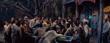 Movie still from “Carmen Jones” (1954), directed by Otto Preminger – A group of people gathered around a piano; Extreme Wide shot, High angle