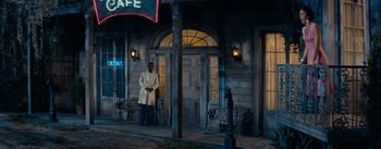 Movie still from “Carmen Jones” (1954), directed by Otto Preminger – A man standing in front of a building at night; Wide shot, Over the shoulder angle