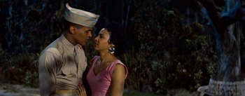 Movie still from “Carmen Jones” (1954), directed by Otto Preminger – A man and a woman are kissing in the dark; Medium shot, Low angle