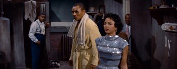 Movie still from “Carmen Jones” (1954), directed by Otto Preminger – A man and a woman standing next to each other; Medium shot, Low angle