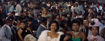 Movie still from “Carmen Jones” (1954), directed by Otto Preminger – A crowd of people standing in a room; Medium shot, High angle