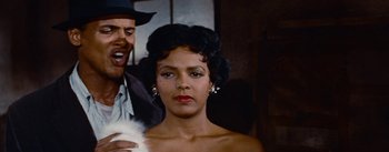 Movie still from “Carmen Jones” (1954), directed by Otto Preminger – A woman in a black dress and a man in a black suit; Close Up shot, Over the shoulder angle