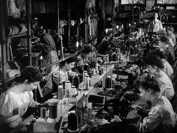 Movie still from “Carrie” (1952), directed by William Wyler – A group of people working in an industrial setting; Wide shot, High angle