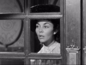 Movie still from “Carrie” (1952), directed by William Wyler – A black and white photo of a woman looking out of a window; Close Up shot, High angle