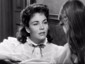 Movie still from “Carrie” (1952), directed by William Wyler – A young woman looking at her reflection in a mirror; Close Up shot, Over the shoulder angle