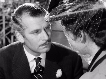 Movie still from “Carrie” (1952), directed by William Wyler – A man and a woman are looking at each other; Close Up shot, Over the shoulder angle