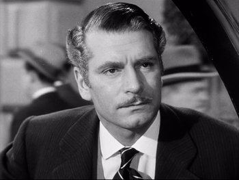 Movie still from “Carrie” (1952), directed by William Wyler – An older man in a suit and tie looking to his left; Close Up shot, High angle