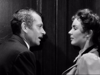 Movie still from “Carrie” (1952), directed by William Wyler – An older man and a younger woman talking to each other; Close Up shot, High angle