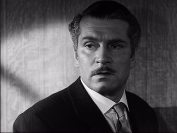 Movie still from “Carrie” (1952), directed by William Wyler – Black and white photograph of a man in a suit and tie; Close Up shot, Low angle