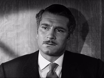 Movie still from “Carrie” (1952), directed by William Wyler – Black and white photograph of a man in a suit; Close Up shot, High angle