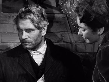 Movie still from “Carrie” (1952), directed by William Wyler – A black and white photo of a man and a woman; Close Up shot, Over the shoulder angle