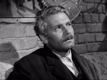 Movie still from “Carrie” (1952), directed by William Wyler – Black and white photograph of a man in a suit and tie; Close Up shot, Over the shoulder angle