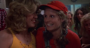 Movie still from “Carrie” (1976), directed by Brian De Palma – Two women are talking and laughing together; Close Up shot, Over the shoulder angle