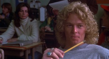 Movie still from “Carrie” (1976), directed by Brian De Palma – A man holding a pencil sitting in front of a woman; Close Up shot, Low angle