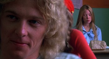 Movie still from “Carrie” (1976), directed by Brian De Palma – A person with long blonde curly hair; Close Up shot, Low angle