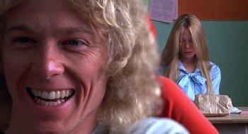 Movie still from “Carrie” (1976), directed by Brian De Palma – A woman with long blonde hair smiling at the camera; Close Up shot, Low angle