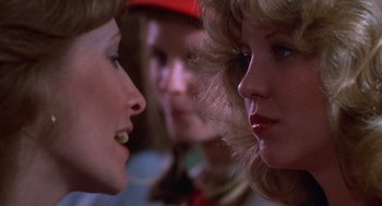 Movie still from “Carrie” (1976), directed by Brian De Palma – A group of women standing next to each other; Close Up shot, Over the shoulder angle