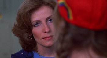 Movie still from “Carrie” (1976), directed by Brian De Palma – A woman's face in a mirror; Close Up shot, Over the shoulder angle