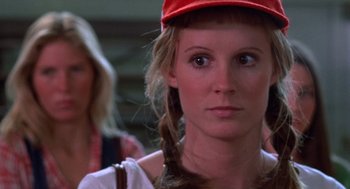Movie still from “Carrie” (1976), directed by Brian De Palma – A person wearing a red hat; Close Up shot, Over the shoulder angle