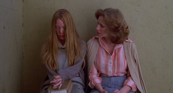 Movie still from “Carrie” (1976), directed by Brian De Palma – Two women sitting next to each other on a bench; Medium shot, High angle