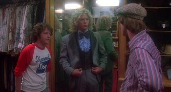 Movie still from “Carrie” (1976), directed by Brian De Palma – A group of men standing in front of a mirror; Medium shot, Over the shoulder angle