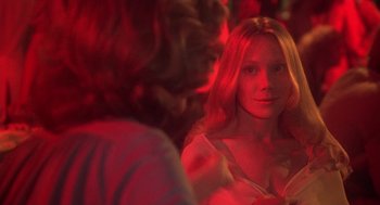 Movie still from “Carrie” (1976), directed by Brian De Palma – A woman is looking at a man in a red light; Close Up shot, Over the shoulder angle