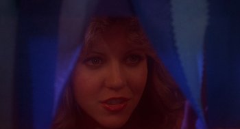 Movie still from “Carrie” (1976), directed by Brian De Palma – A woman's face through a blue curtain; Close Up shot, Low angle