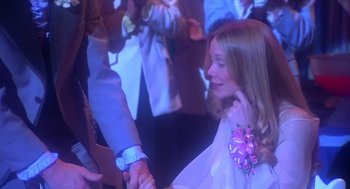 Movie still from “Carrie” (1976), directed by Brian De Palma – A young girl is holding a man's hand while he holds her hand; Medium shot, Over the shoulder angle