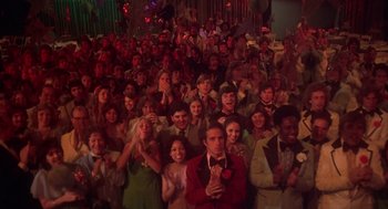 Movie still from “Carrie” (1976), directed by Brian De Palma – A group of people standing in front of each other; Wide shot, High angle