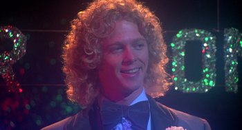 Movie still from “Carrie” (1976), directed by Brian De Palma – A person wearing a suit and bow tie; Close Up shot, Low angle