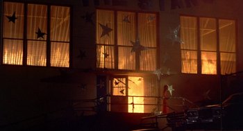 Movie still from “Carrie” (1976), directed by Brian De Palma – A person standing in front of a window with stars hanging from it; Extreme Wide shot, Low angle