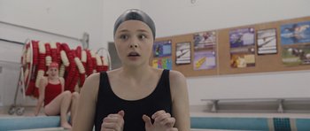 Movie still from “Carrie” (2013), directed by Kimberly Peirce – A woman wearing a swim cap in a swimming pool; Close Up shot, Over the shoulder angle