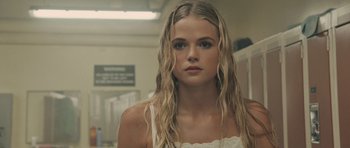 Movie still from “Carrie” (2013), directed by Kimberly Peirce – A beautiful young woman with long blonde hair and blue eyes; Close Up shot, Low angle