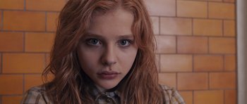 Movie still from “Carrie” (2013), directed by Kimberly Peirce – A person with long red hair; Close Up shot, Low angle