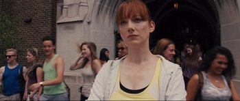 Movie still from “Carrie” (2013), directed by Kimberly Peirce – A woman with red hair is standing in front of a group of people; Close Up shot, Low angle