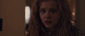 Movie still from “Carrie” (2013), directed by Kimberly Peirce – A person with long curly hair; Close Up shot, Low angle