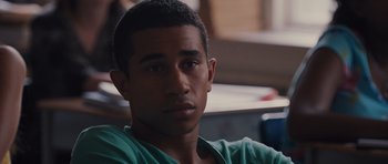Movie still from “Carrie” (2013), directed by Kimberly Peirce – A man with a green shirt is looking at the camera; Close Up shot, Over the shoulder angle