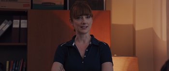 Movie still from “Carrie” (2013), directed by Kimberly Peirce – A woman in a blue shirt is posing for a picture; Close Up shot, Over the shoulder angle