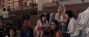Movie still from “Carrie” (2013), directed by Kimberly Peirce – A group of women sitting in a room next to each other; Medium shot, Over the shoulder angle