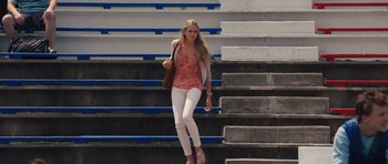 Movie still from “Carrie” (2013), directed by Kimberly Peirce – A beautiful young lady walking up some steps; Wide shot, Low angle
