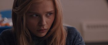 Movie still from “Carrie” (2013), directed by Kimberly Peirce – A person with long blonde hair; Close Up shot, Low angle