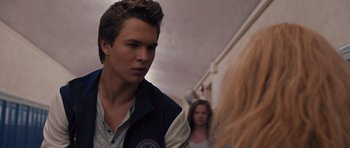 Movie still from “Carrie” (2013), directed by Kimberly Peirce – A man standing next to a woman in front of a building; Close Up shot, Over the shoulder angle