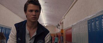 Movie still from “Carrie” (2013), directed by Kimberly Peirce – A young man standing in a school hallway; Close Up shot, Over the shoulder angle