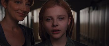 Movie still from “Carrie” (2013), directed by Kimberly Peirce – A young girl with long red hair; Close Up shot, High angle