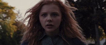 Movie still from “Carrie” (2013), directed by Kimberly Peirce – A person with long red hair; Close Up shot, Low angle