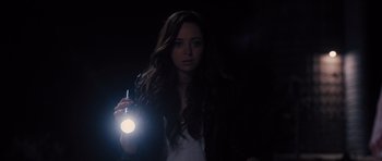 Movie still from “Carrie” (2013), directed by Kimberly Peirce – A woman holding a flashlight in the dark; Close Up shot, High angle