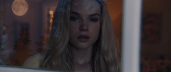 Movie still from “Carrie” (2013), directed by Kimberly Peirce – A woman with long blonde hair looking out of a window; Close Up shot, Low angle